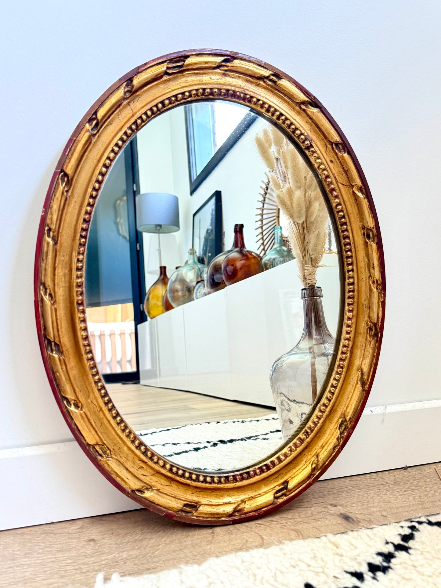 Miroir ancien doré de forme ovale