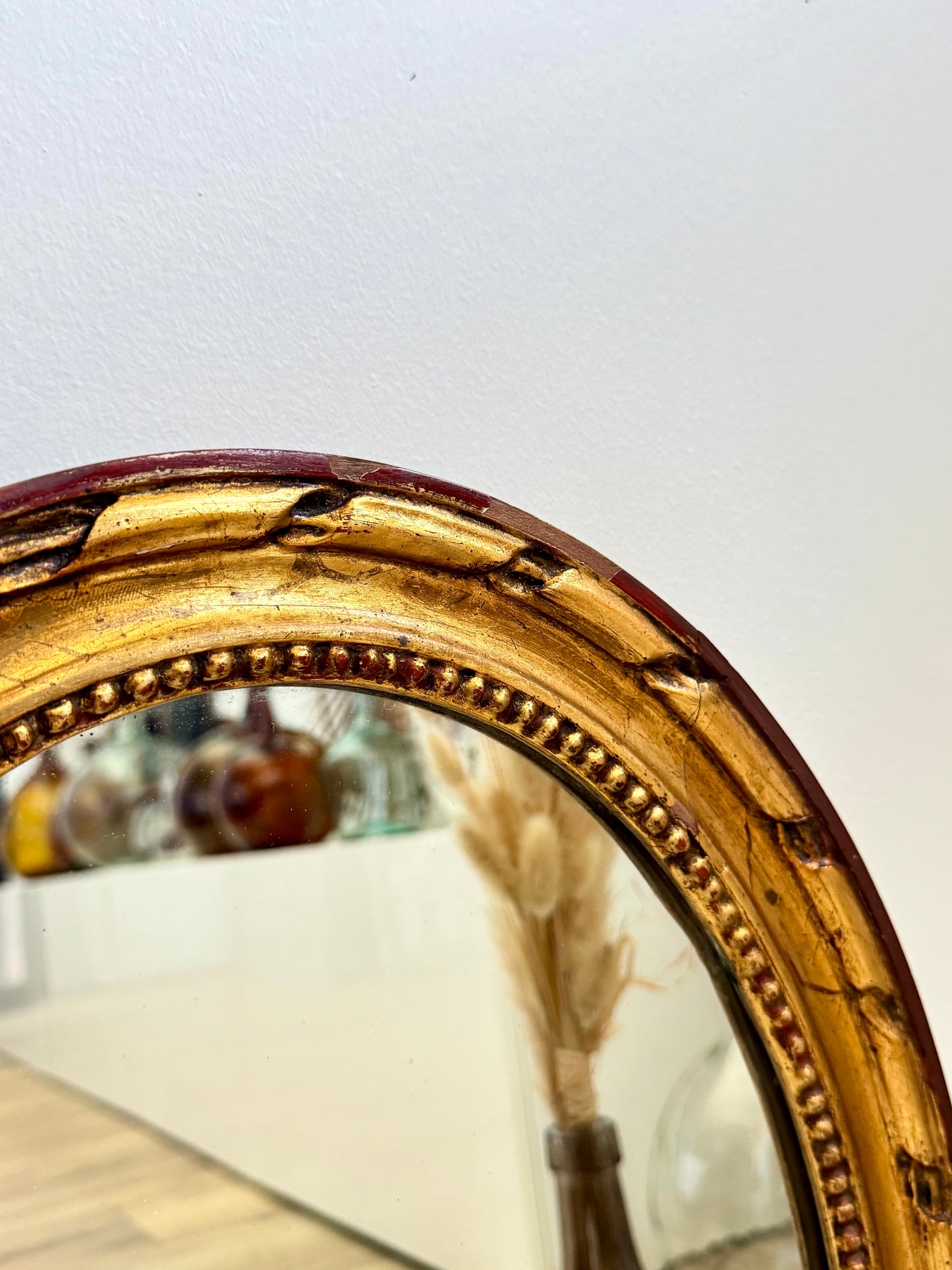 Miroir ancien doré de forme ovale